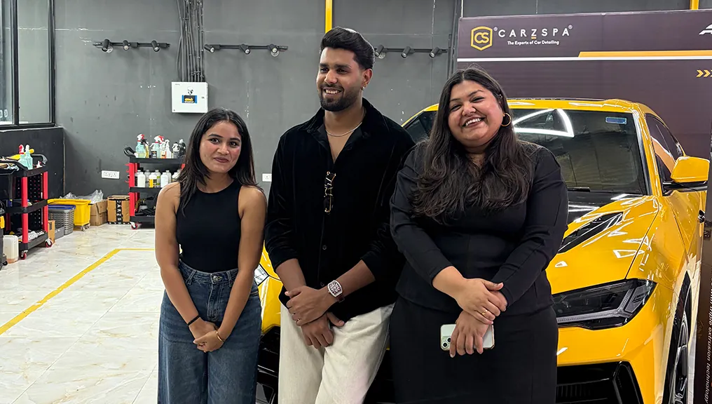 Creators filming branded content on the floor of a CarzSpa detailing studio