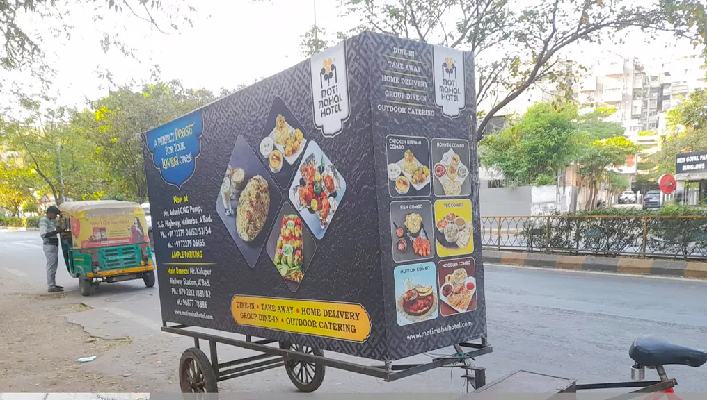 Moti Mahal branded cart on the S.G. Highway showing the combo menu and both branch addresses