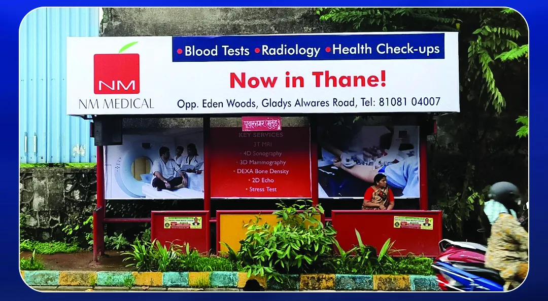 NM Medical bus shelter header announcing the new Thane centre with its address