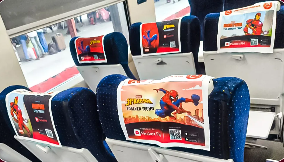 Pocket FM Marvel headrest covers on train seats with QR codes to the audio series