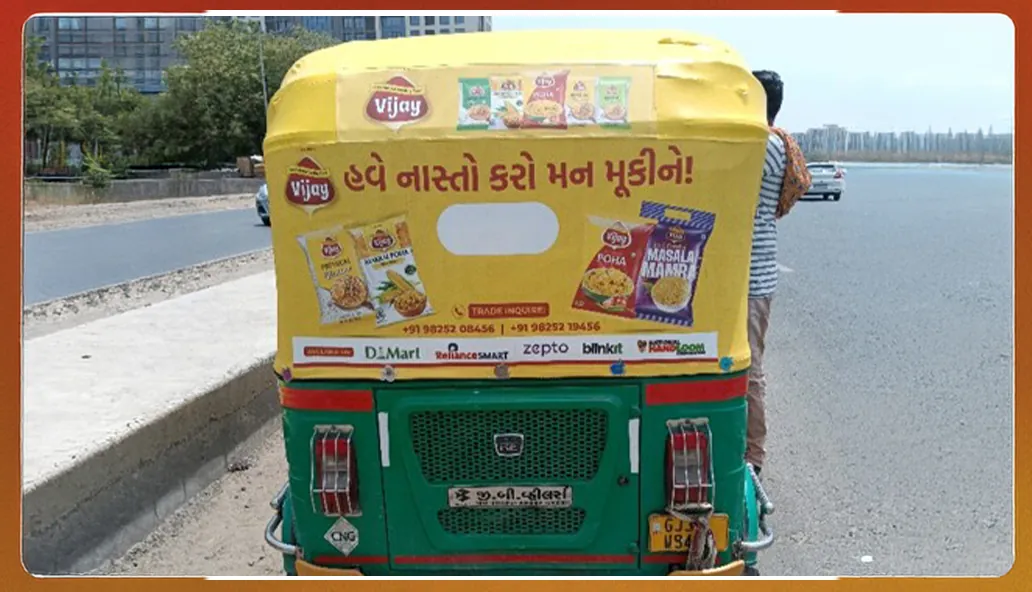 Vijay Mamra auto-rickshaw hood in Gujarati showing the snack range and retail partners