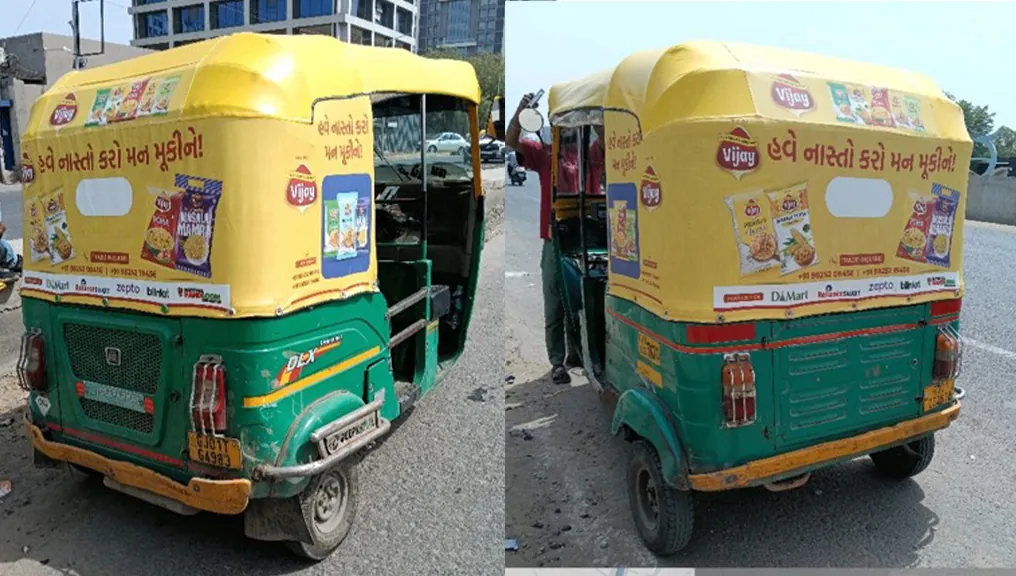 Two Vijay branded autos photographed on the Ahmedabad roads
